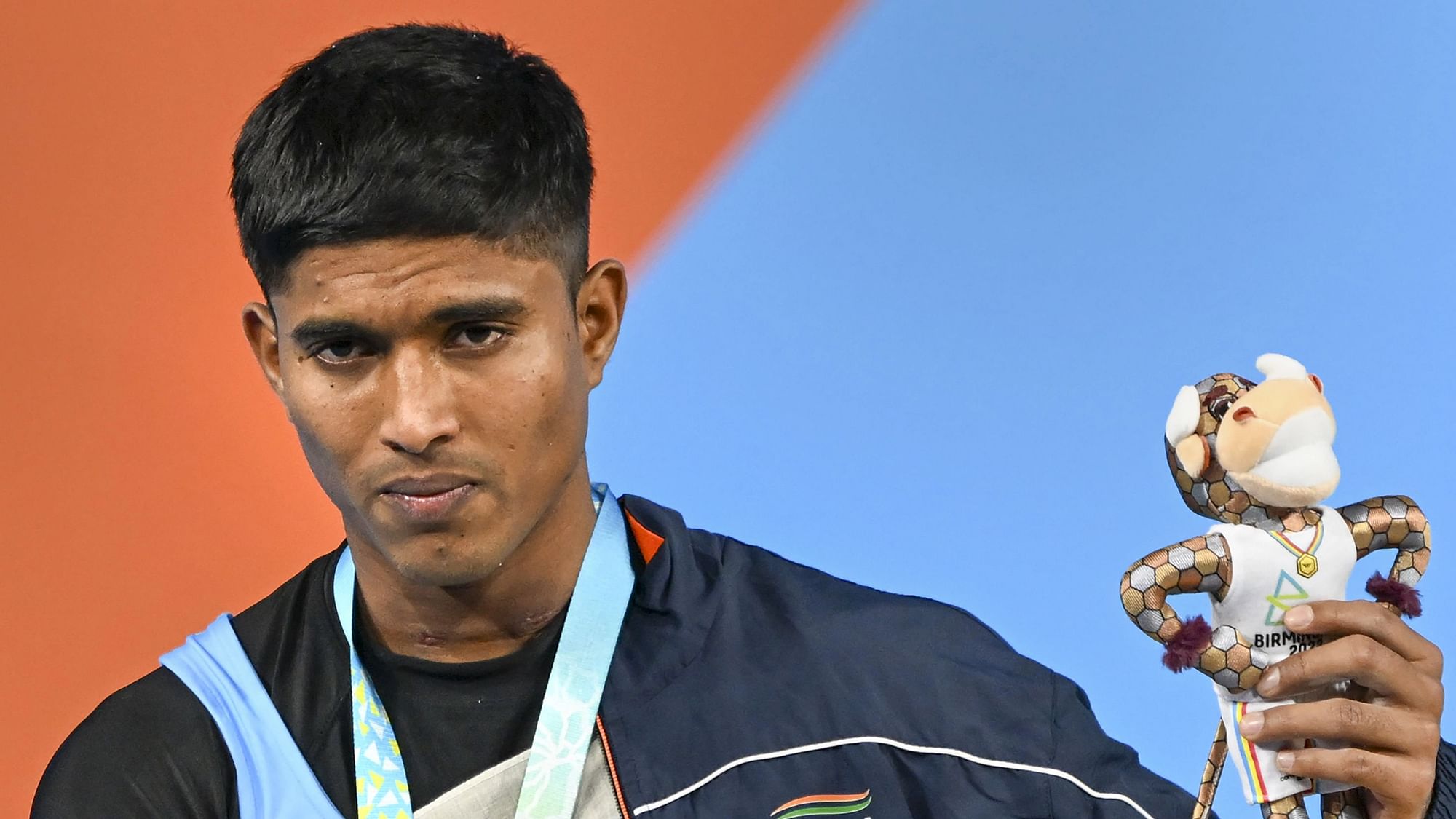 <div class="paragraphs"><p>Indian weightlifter Sanket Sargar poses for a photo after winning the silver medal in the men's 55kg category weightlifting at the Commonwealth Games on Saturday.</p></div>