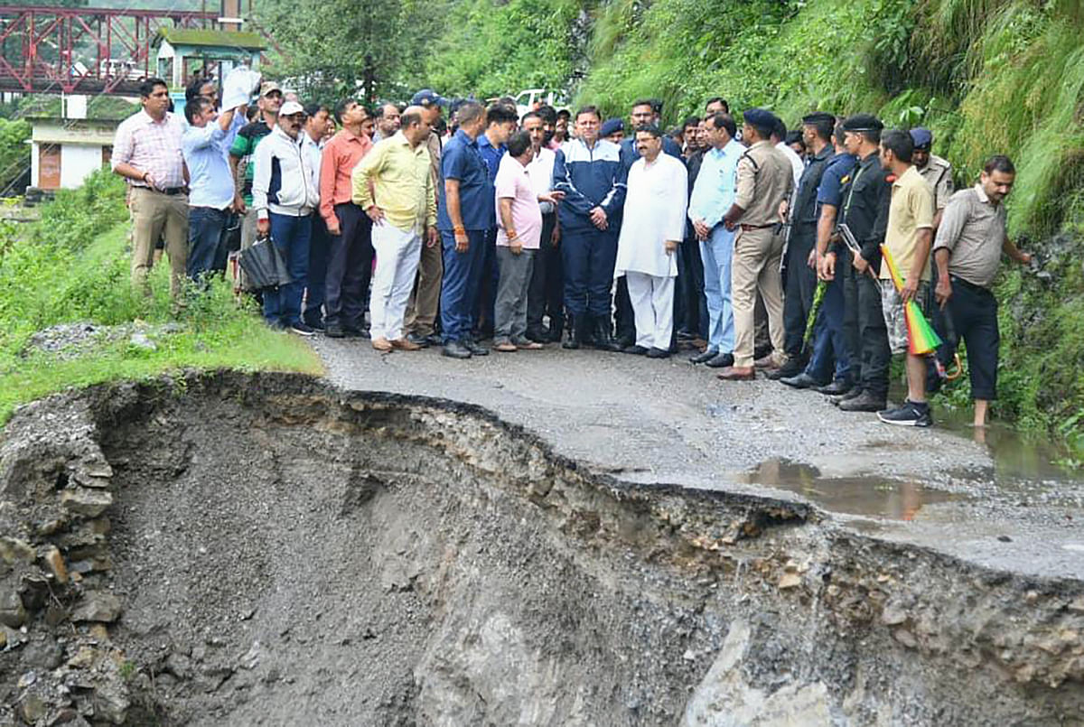 <div class="paragraphs"><p>Dehradun: Uttarakhand Chief Minister Pushkar Singh Dhami stands near a damaged road during his visit to the affected areas after a cloudburst in Dehradun.</p></div>