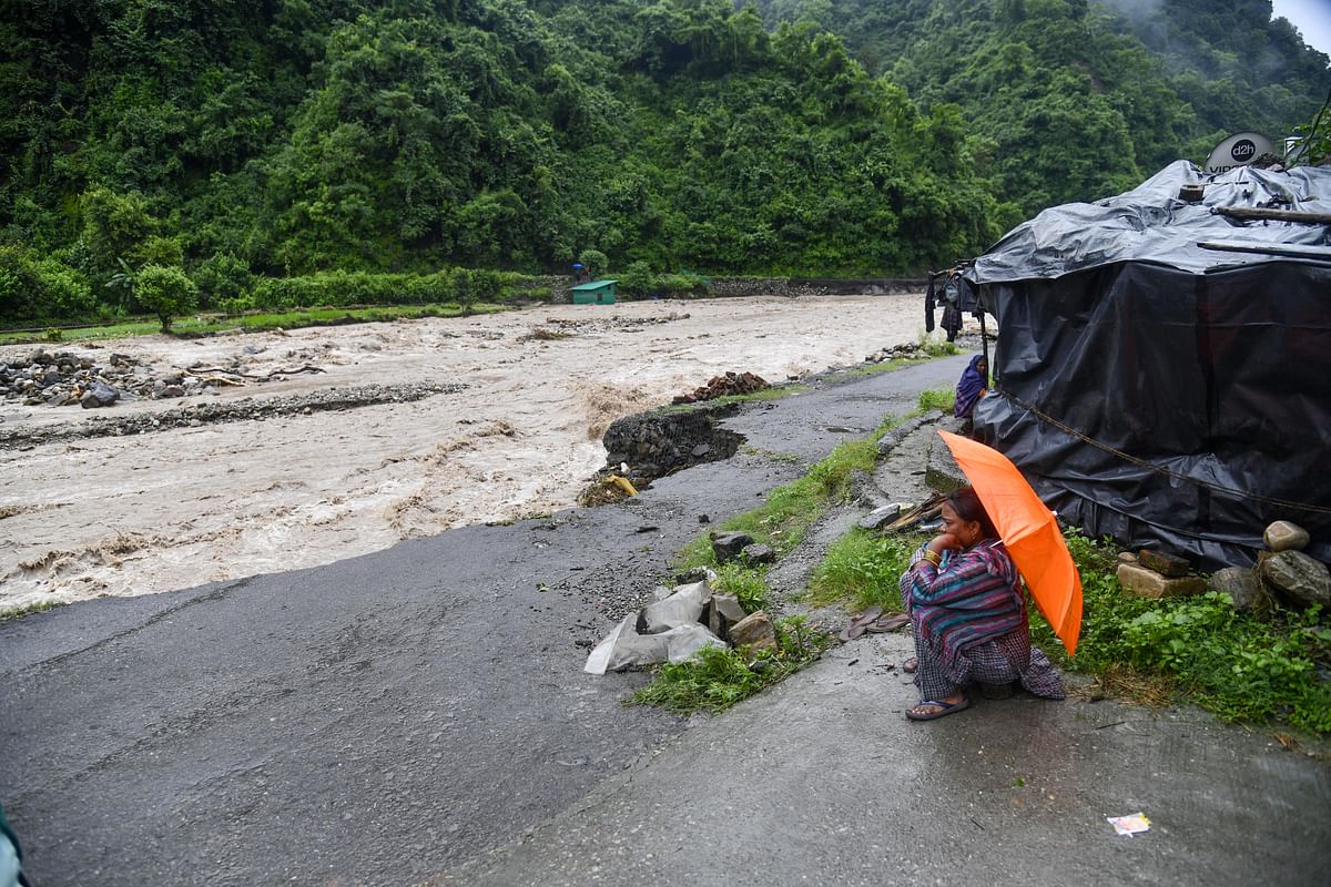 <div class="paragraphs"><p>Dehradun: A woman sits on the banks of swollen Song river, after a series of cloudbursts hit different parts of Uttarakhand during the monsoon season, at Raipur area in Dehradun district.</p></div>