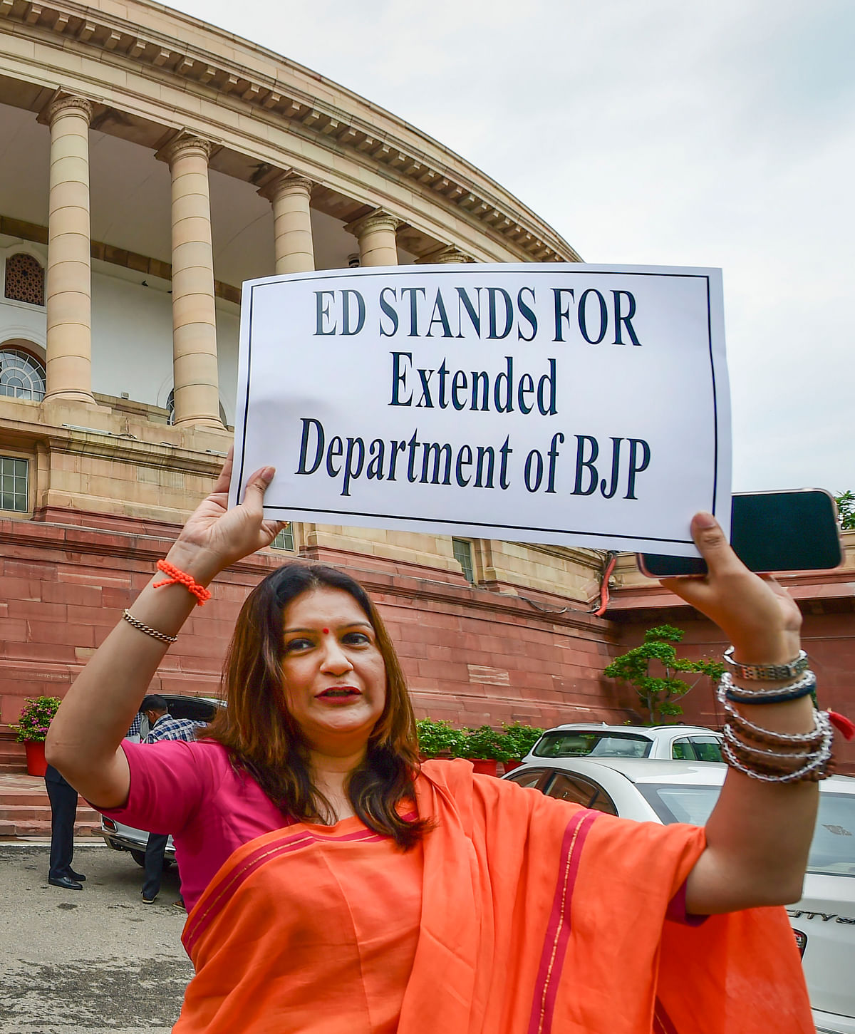 <div class="paragraphs"><p>Shiv Sena MP Priyanka Chaturvedi holds a placard in protest against ED at Parliament House complex, during ongoing Monsoon Session.</p></div>