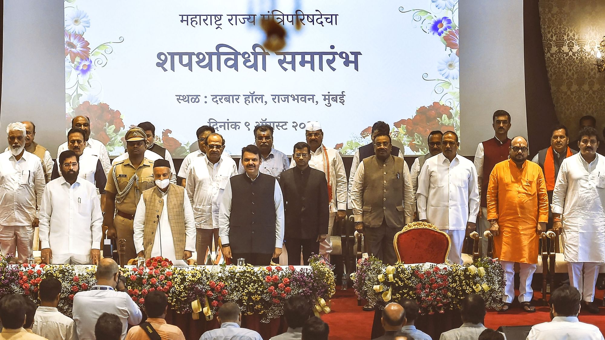 <div class="paragraphs"><p>Maharashtra Governor Bhagat Singh Koshyari, Chief Minister Eknath Shinde, and Dy CM Devendra Fadnavis with newly sworn-in ministers, at a ceremony at Raj Bhavan in Mumbai, Tuesday, 9 August.</p></div>