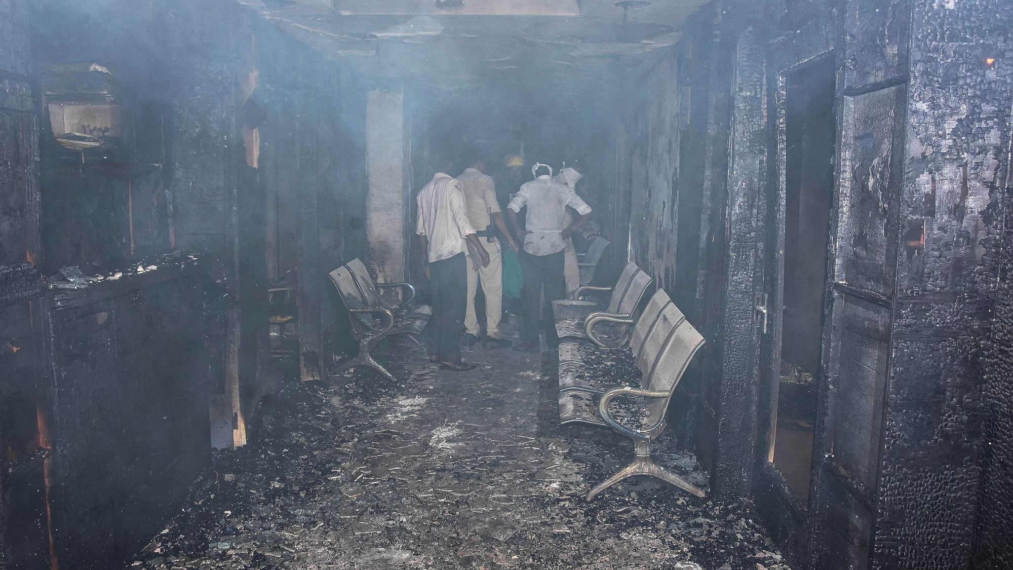 <div class="paragraphs"><p>Police and fire personnel inspect after a major fire broke out at the Life Multi-speciality Hospital at Damoh Naka, in Jabalpur, on Monday,  1 August. Eight patients died in the incident.</p></div>