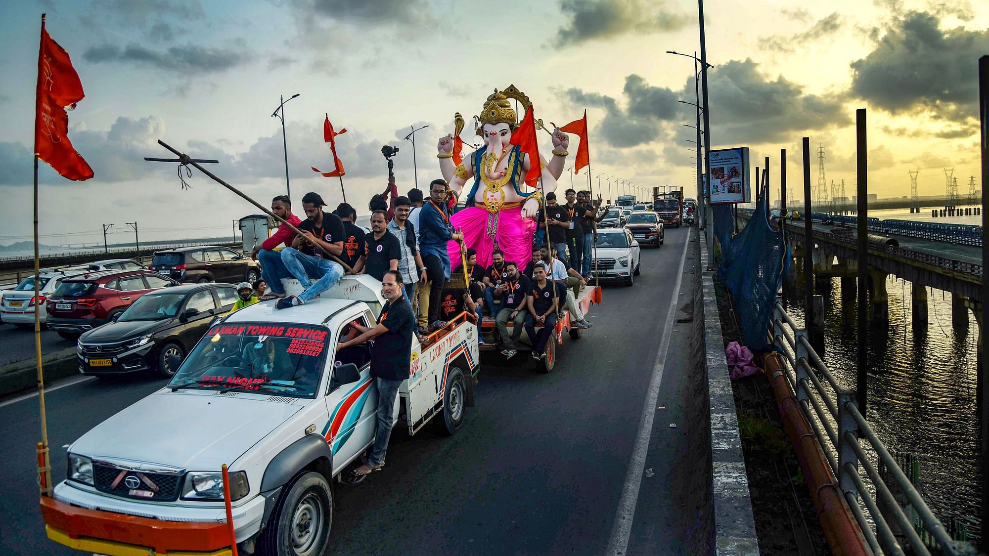 <div class="paragraphs"><p>Devotees carry an idol of Lord Ganesh during a procession ahead of the Ganesh Chaturthi festival, in Navi Mumbai, Sunday, 28 August.</p></div>