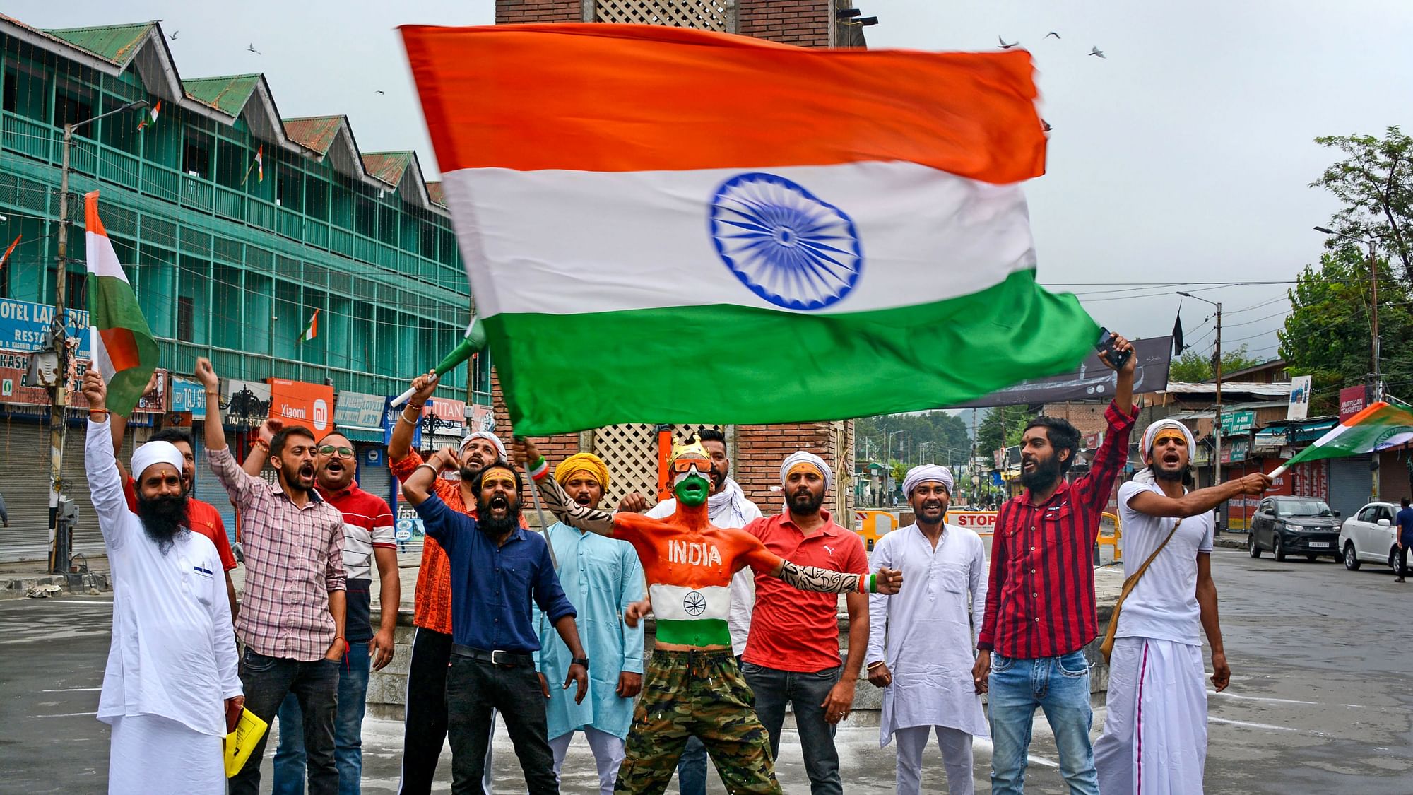 <div class="paragraphs"><p>People wave the tricolour celebrating the 76th Independence Day, at Ghanta Ghar Lal Chowk in Srinagar, on Monday, 15 August.&nbsp;</p></div>