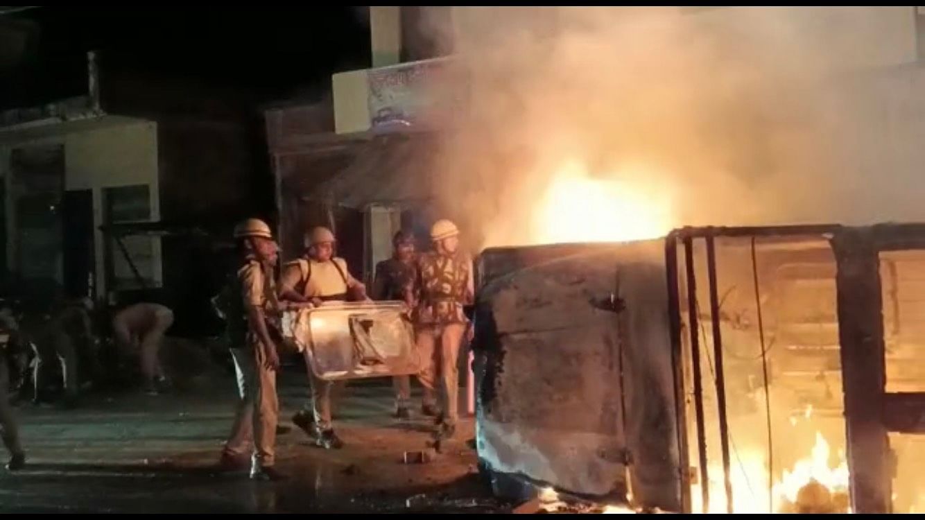 <div class="paragraphs"><p>Police officials trying to douse flames amid protests in Uttar Pradesh's&nbsp;Auraiya on Monday, 26 September.&nbsp;</p></div>