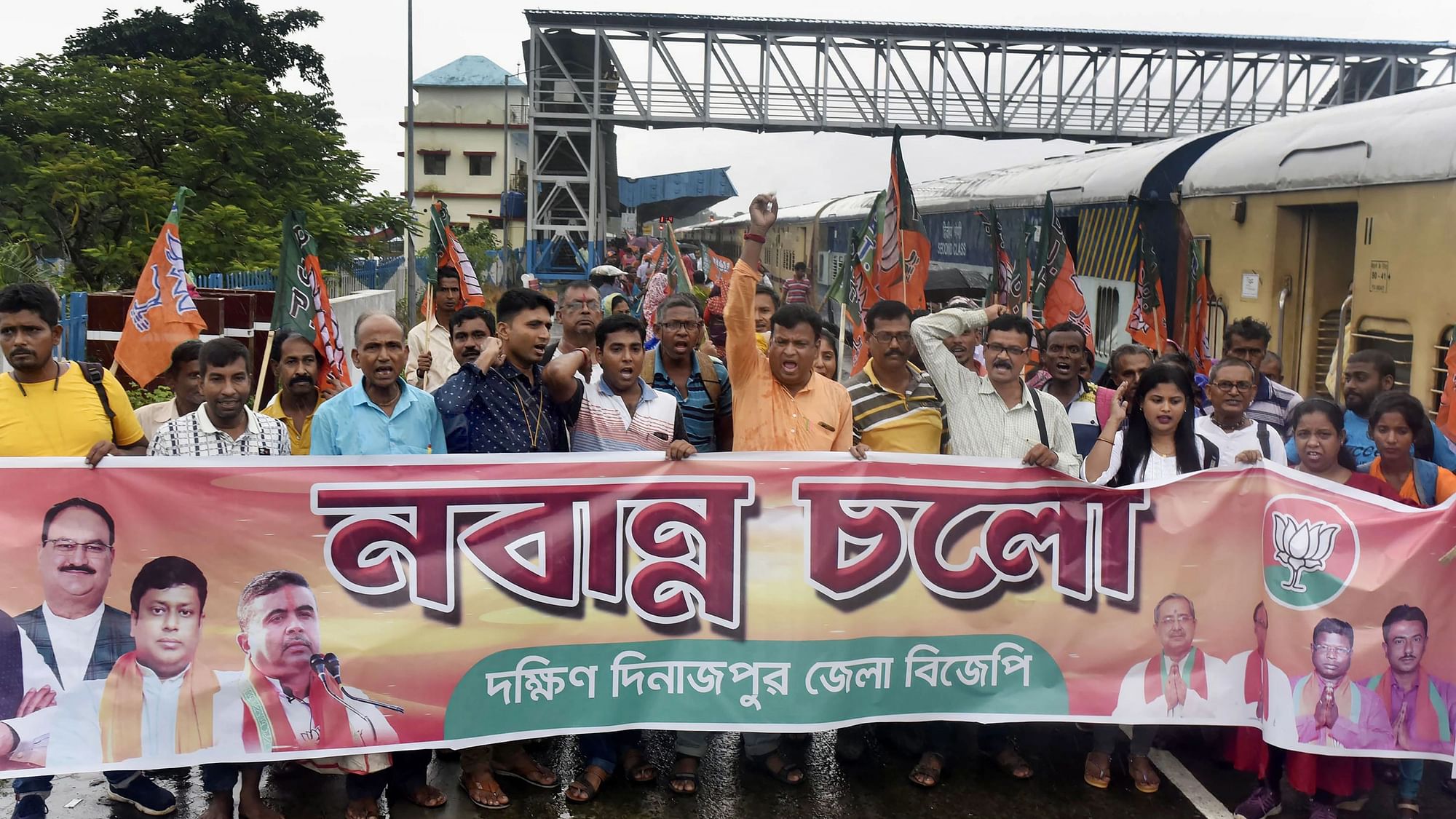 <div class="paragraphs"><p>BJP supporters raise slogans before boarding a Kolkata-bound train to participate in the party's 'Nabanna Abhijan' march at the Balurghat railway station in South Dinajpur district in West Bengal on 12 September.&nbsp;</p></div>