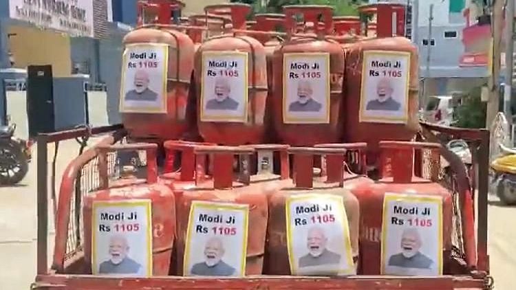 <div class="paragraphs"><p>The posters put up on cooking gas cylinders carried Modi's photographs along with the price of each cylinder at Rs 1,105.</p></div>