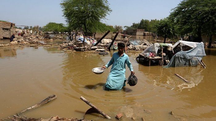 <div class="paragraphs"><p>A man looks for salvageable belongings from his flooded home in the Shikarpur district of Sindh Province, Pakistan.</p></div>