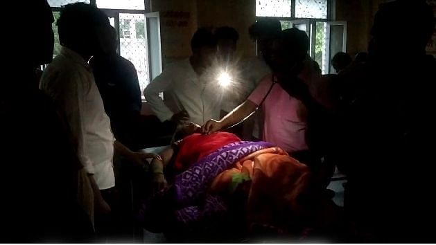 <div class="paragraphs"><p>Ballia, UP: Patient on a stretcher being examined under torchlight as the hospital faces a power cut.</p></div>