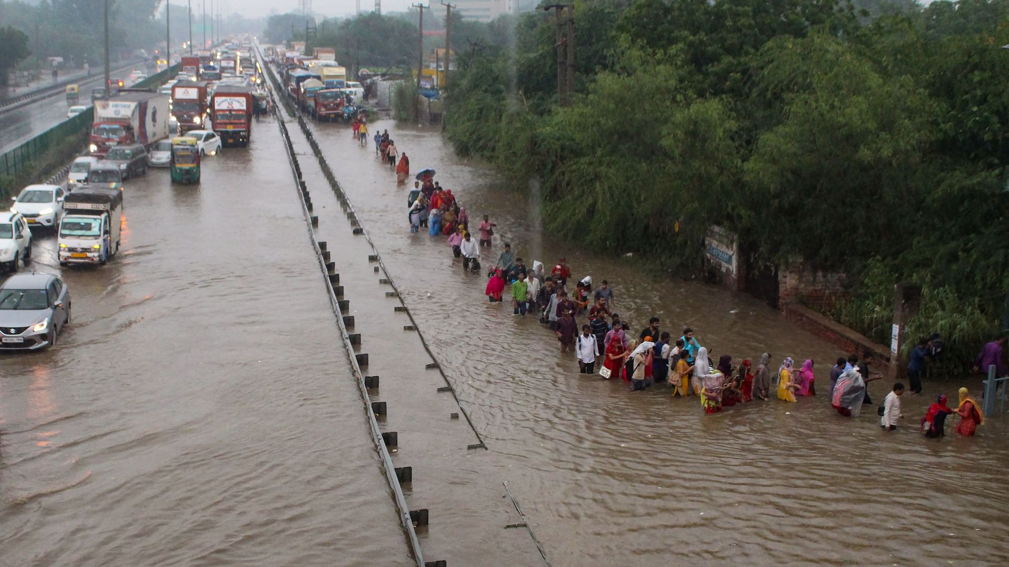 <div class="paragraphs"><p>Gurugram: Commuters wade through the waterlogged Delhi-Gurugram Expressway service road after rainfall, in Gurugram, on Thursday, 22 September 2022.</p></div>
