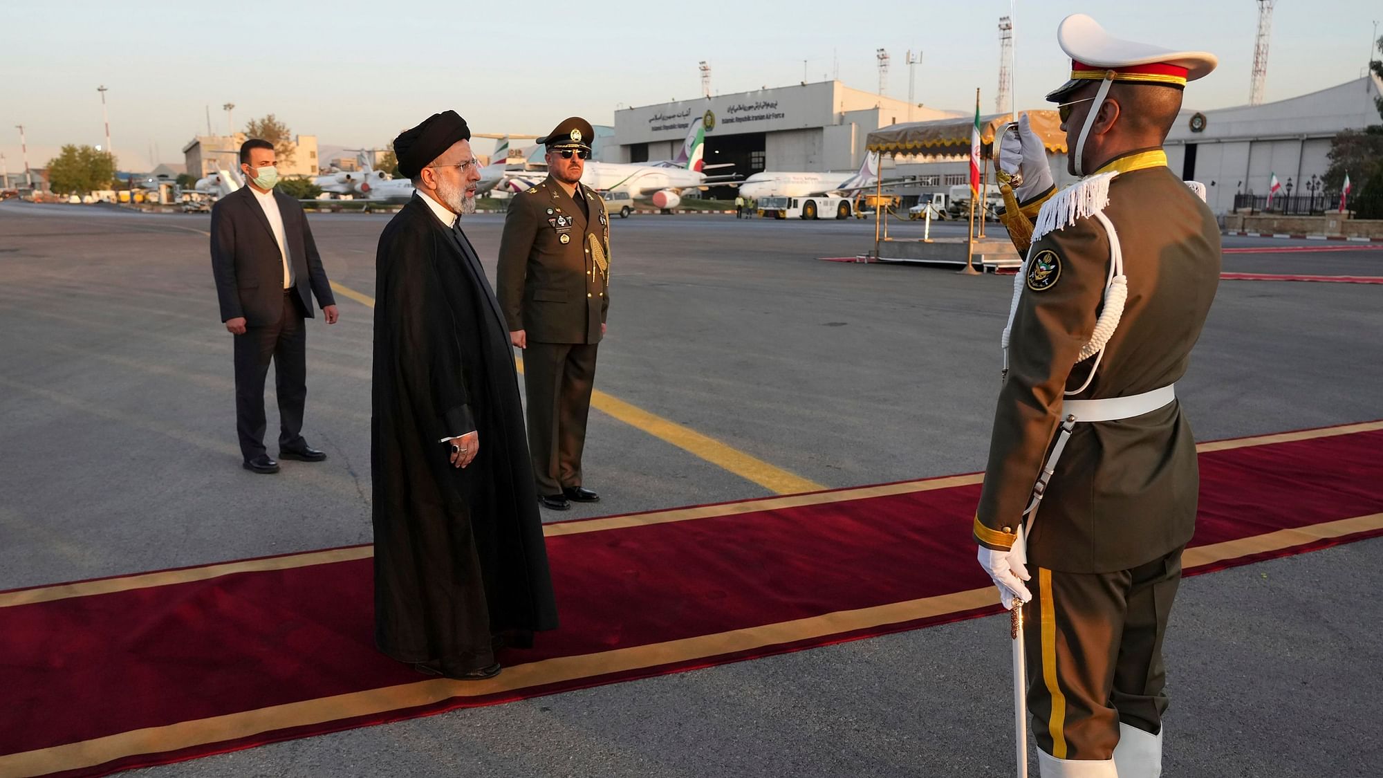 <div class="paragraphs"><p>Iranian President Ebrahim Raisi, second left, reviews an honor guard during his official departure ceremony as he leaves Tehran's Mehrabad airport for New York to attend the annual UN General Assembly meeting, Monday, 19 September.</p></div>