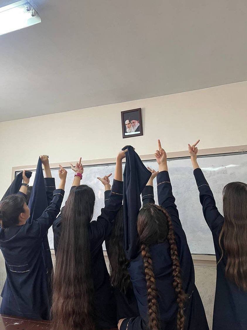 Footage from students' protests shows girls waving hijabs in the air and chanting slogans inside school premises.