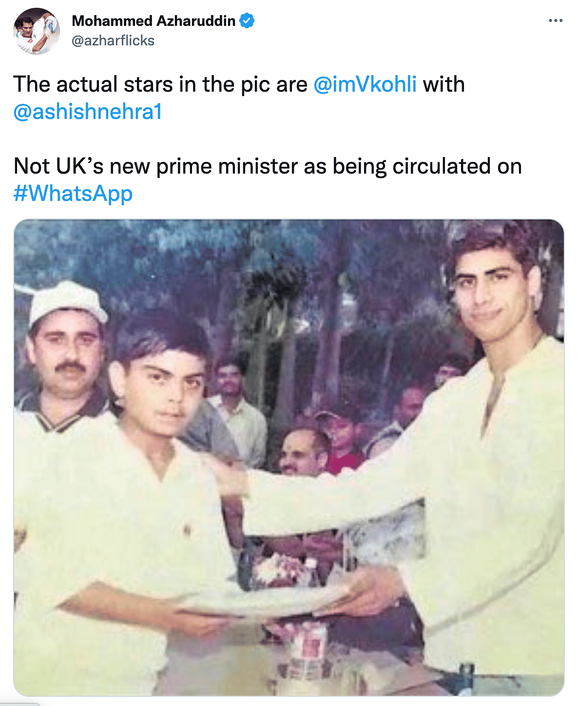The picture is from 2003, which shows young Virat Kohli receiving an award from Ashish Nehra.