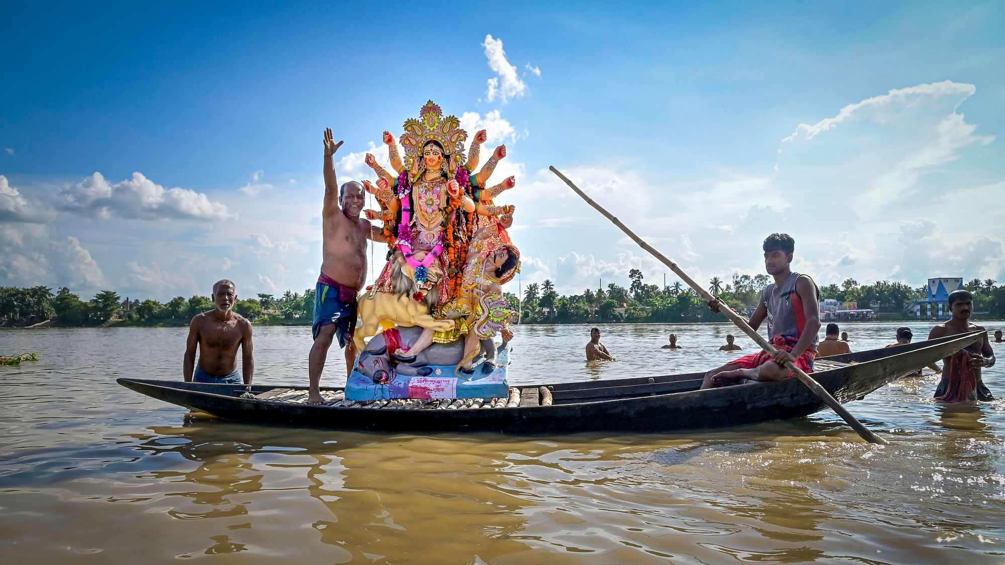 <div class="paragraphs"><p>Devotees carry an idol of Goddess Durga on a boat for immersion in the Hooghly river at the end of Durga Puja festival, in Nadia, Friday, 7 October.</p></div>