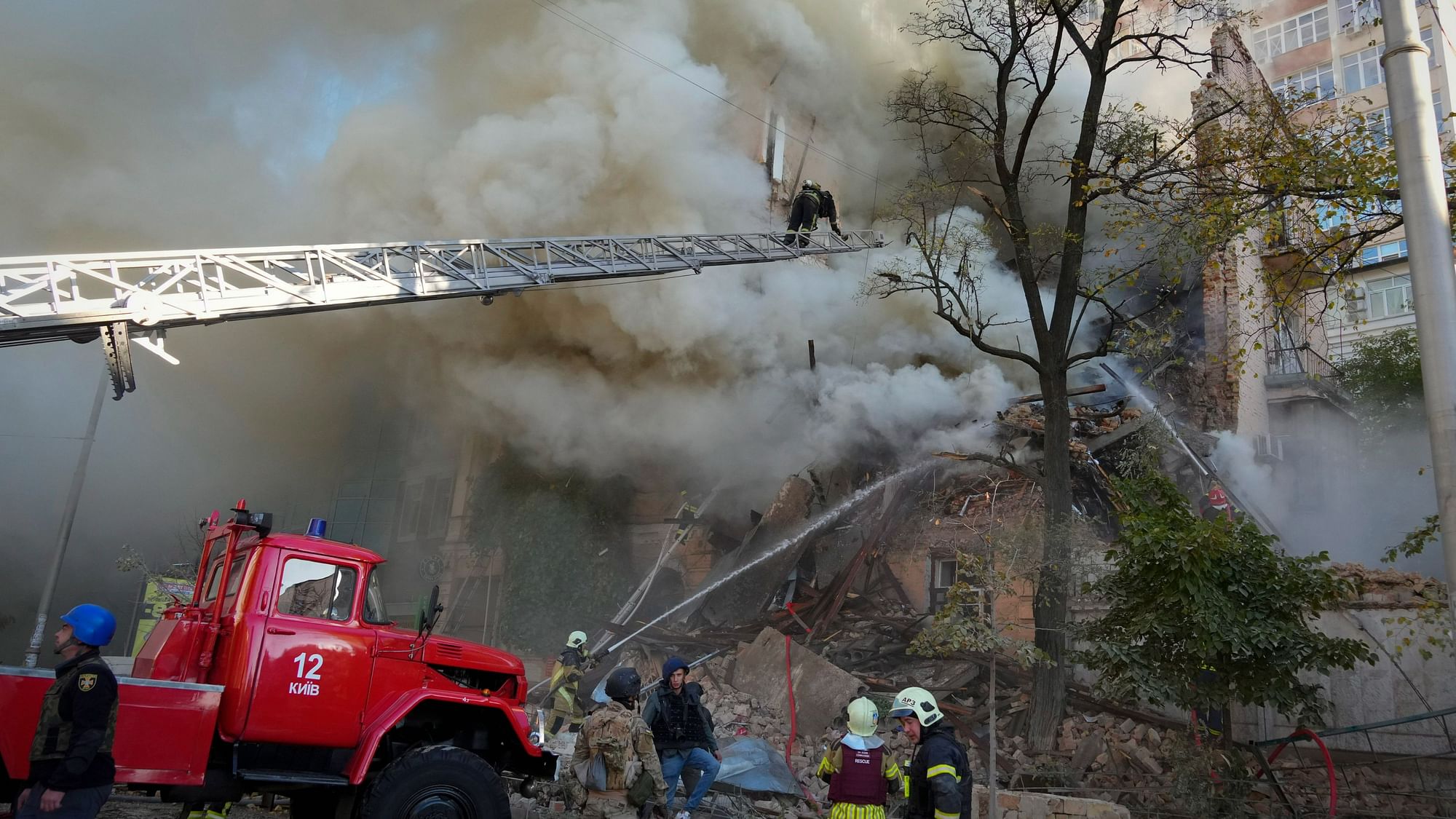 <div class="paragraphs"><p>Firefighters try to douse flames after a drone attack in Ukraine's Kyiv on Monday, 17 October.&nbsp;</p></div>