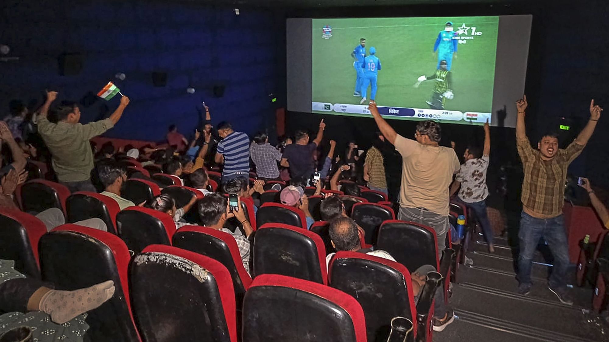 <div class="paragraphs"><p>People celebrate as they watch the live screening of the ICC men's T20 World Cup  match between India and Pakistan, at Satyam INOX, Patel Nagar in New Delhi on Sunday. </p></div>