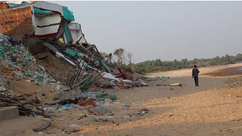 <div class="paragraphs"><p>A man walks along the Ramayapatnam coast at Ganjam in Odisha. Several houses here along the coast are at the verge of collapse due to increased coastal erosion.</p></div>