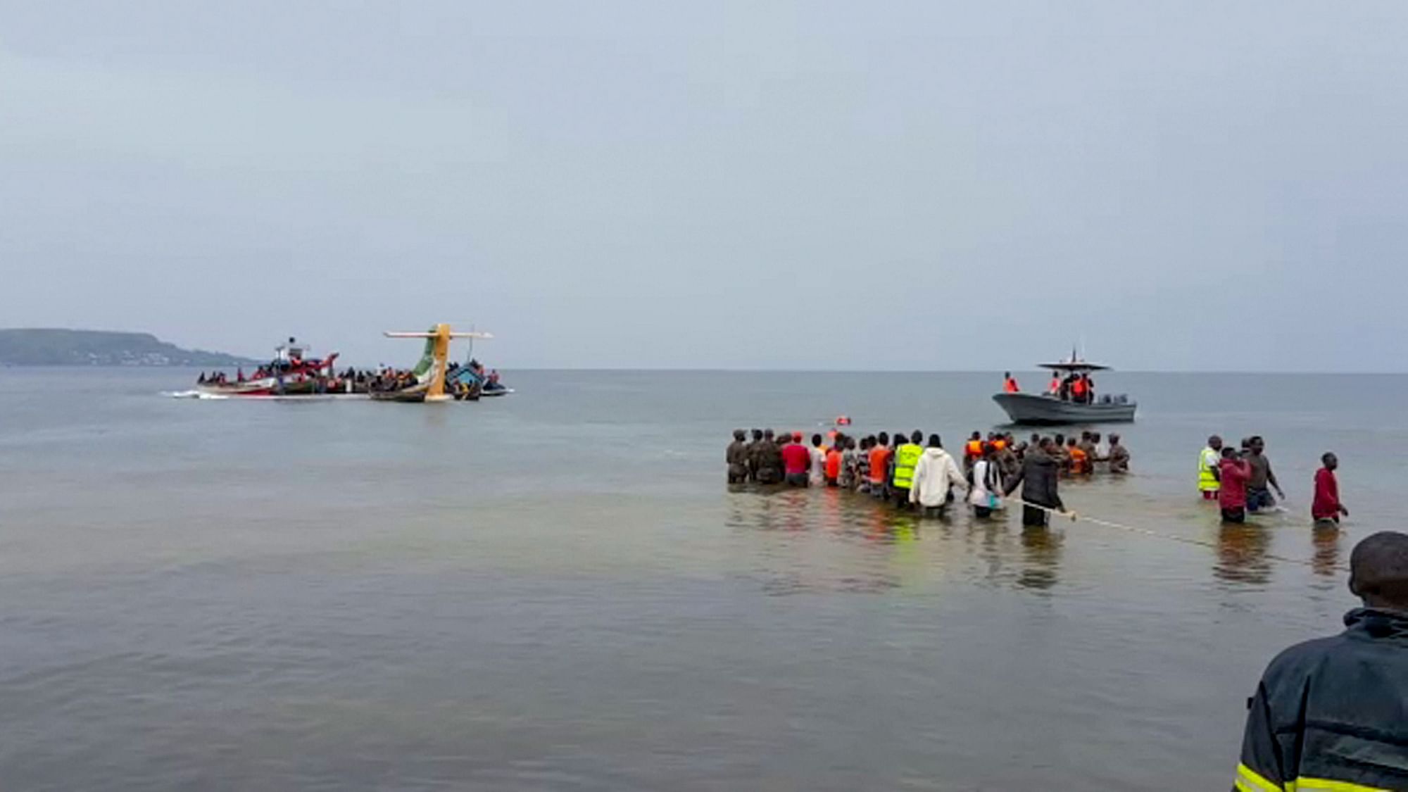 <div class="paragraphs"><p>Rescuers in boats and  in the water are seen around the tail fin of a crashed Precision Air passenger aircraft on the shores of Lake Victoria in Bukoba, in western Tanzania on Sunday, November 6 2022. </p></div>