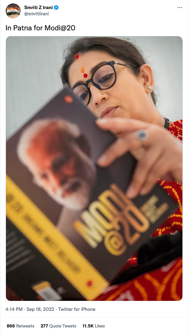 The original picture shows Irani reading a book on PM Modi's public life, titled 'Modi@20: Dreams Meet Delivery.'