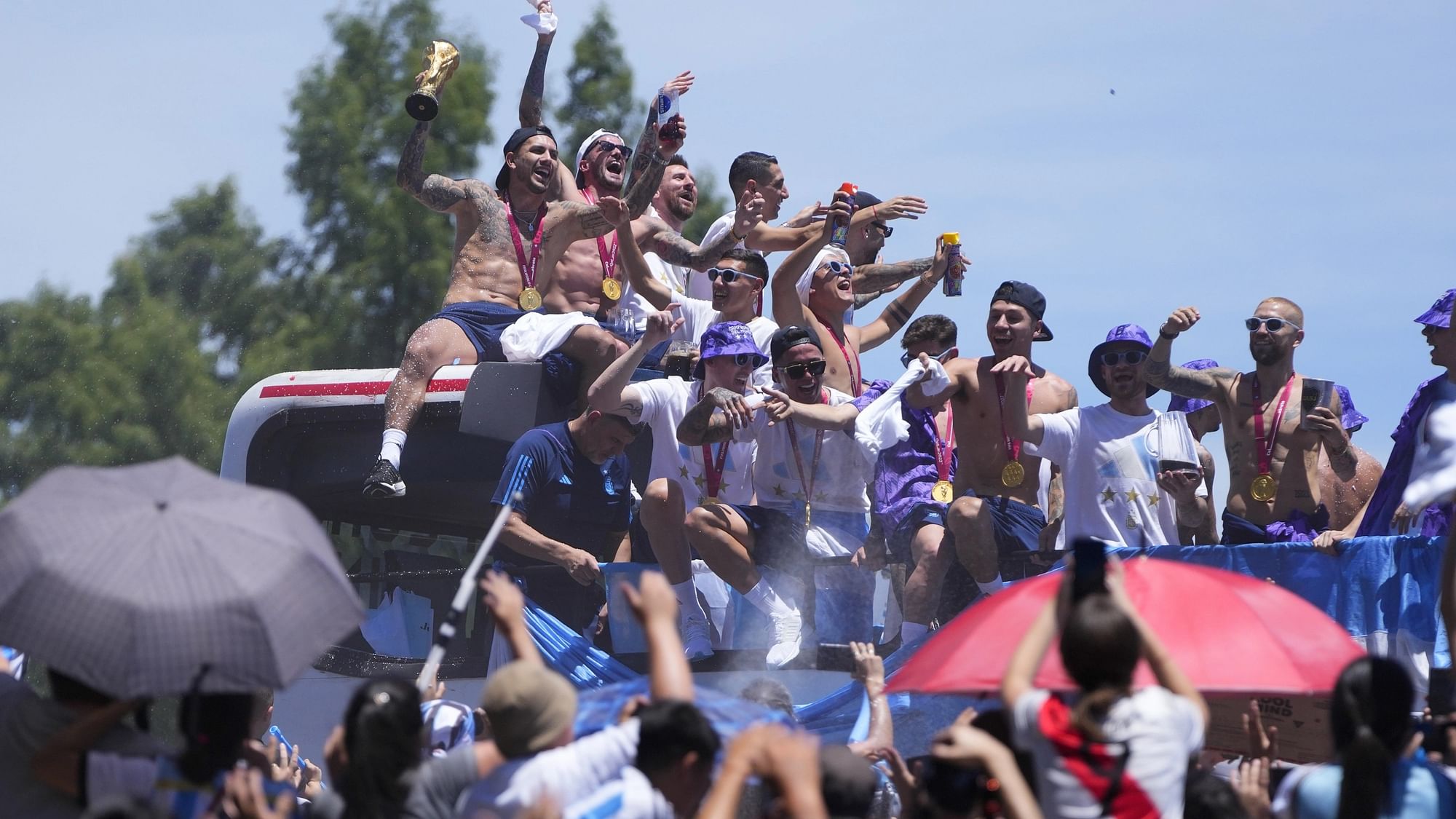 <div class="paragraphs"><p>Argentina's World Cup-winning squad celebrate on top of a bus during the victory parade in Buenos Aires.</p></div>