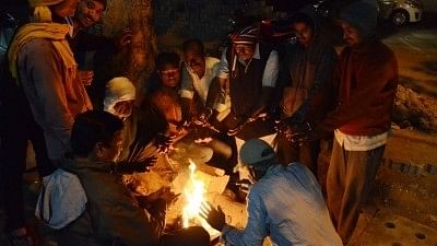 <div class="paragraphs"><p>People warm themselves around a fire on a chilly winter evening. </p></div>