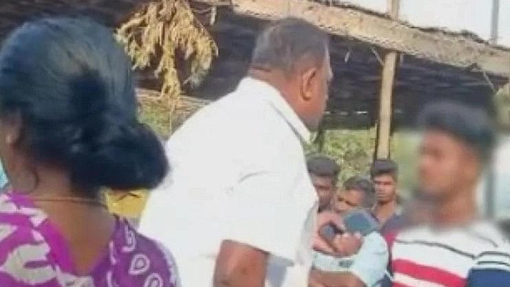 <div class="paragraphs"><p>Screenshot of the purported video in which DMK Union Secretary Manickam is seen abusing a boy for entering temple in Salem, TN.</p></div>