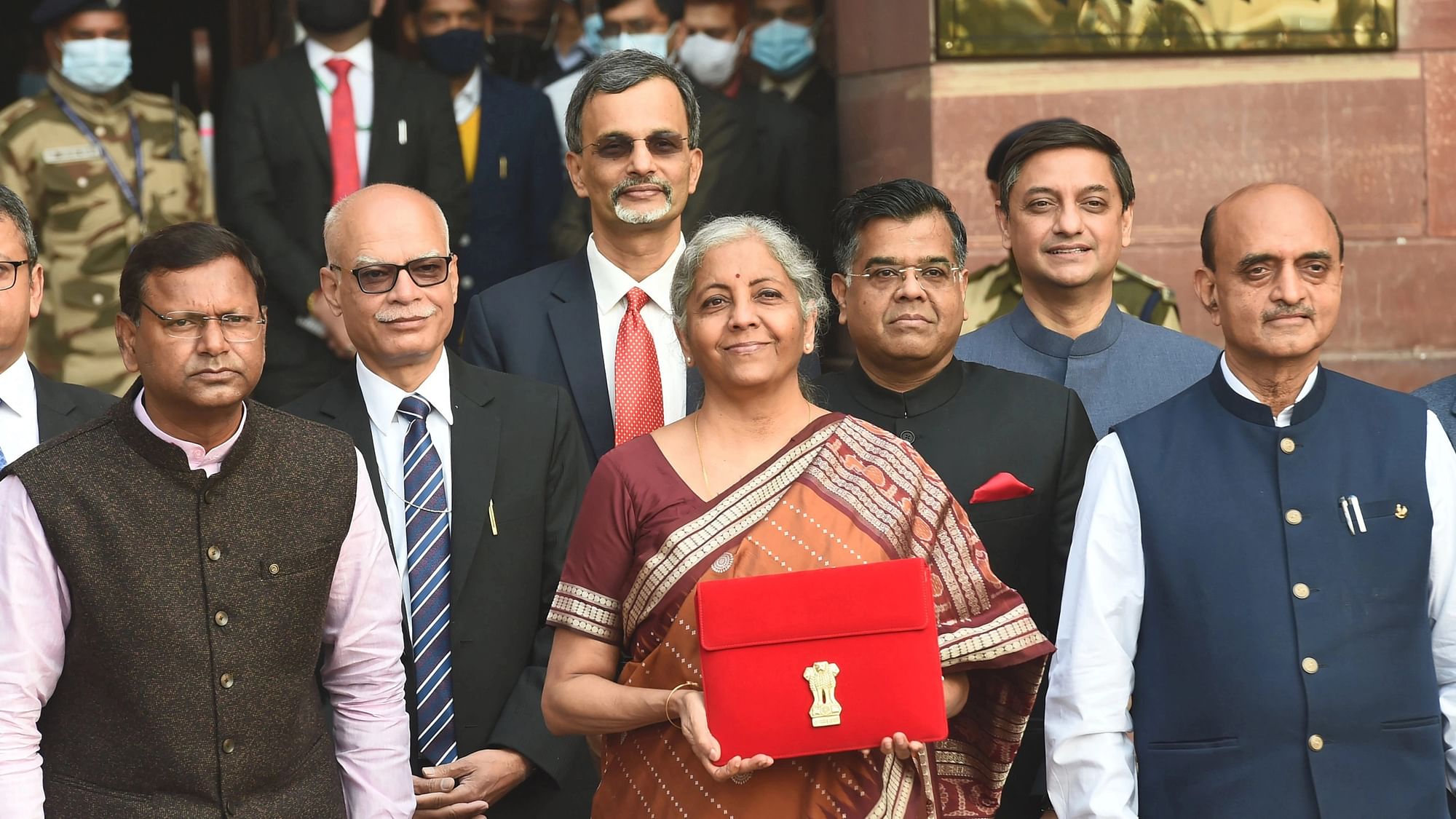 <div class="paragraphs"><p>A file photo of Union Finance Minister Nirmala Sitharaman holding a folder case containing the Union Budget 2022 as she poses for a group photograph with MoS Finance Pankaj Chaudhary and officials of the Finance Ministry, at North Block in New Delhi, on Tuesday, 1 February 2022. </p></div>