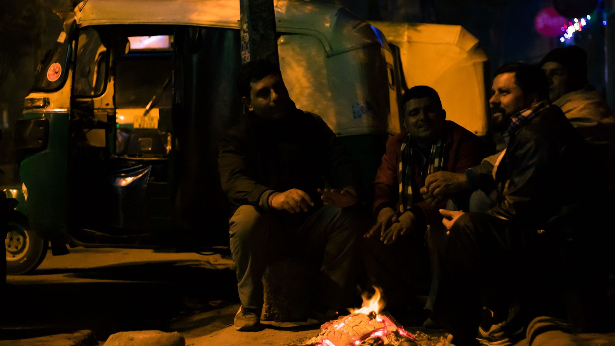 <div class="paragraphs"><p>Auto drivers huddle up around a fire at around 2 am on one of the coldest night so far.&nbsp;</p></div>