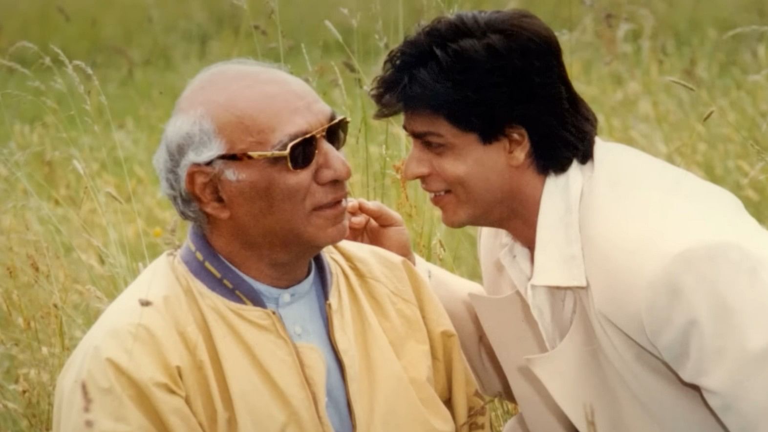 <div class="paragraphs"><p>Shah Rukh Khan with Yash Chopra in a still from<em> The Romantics</em></p></div>