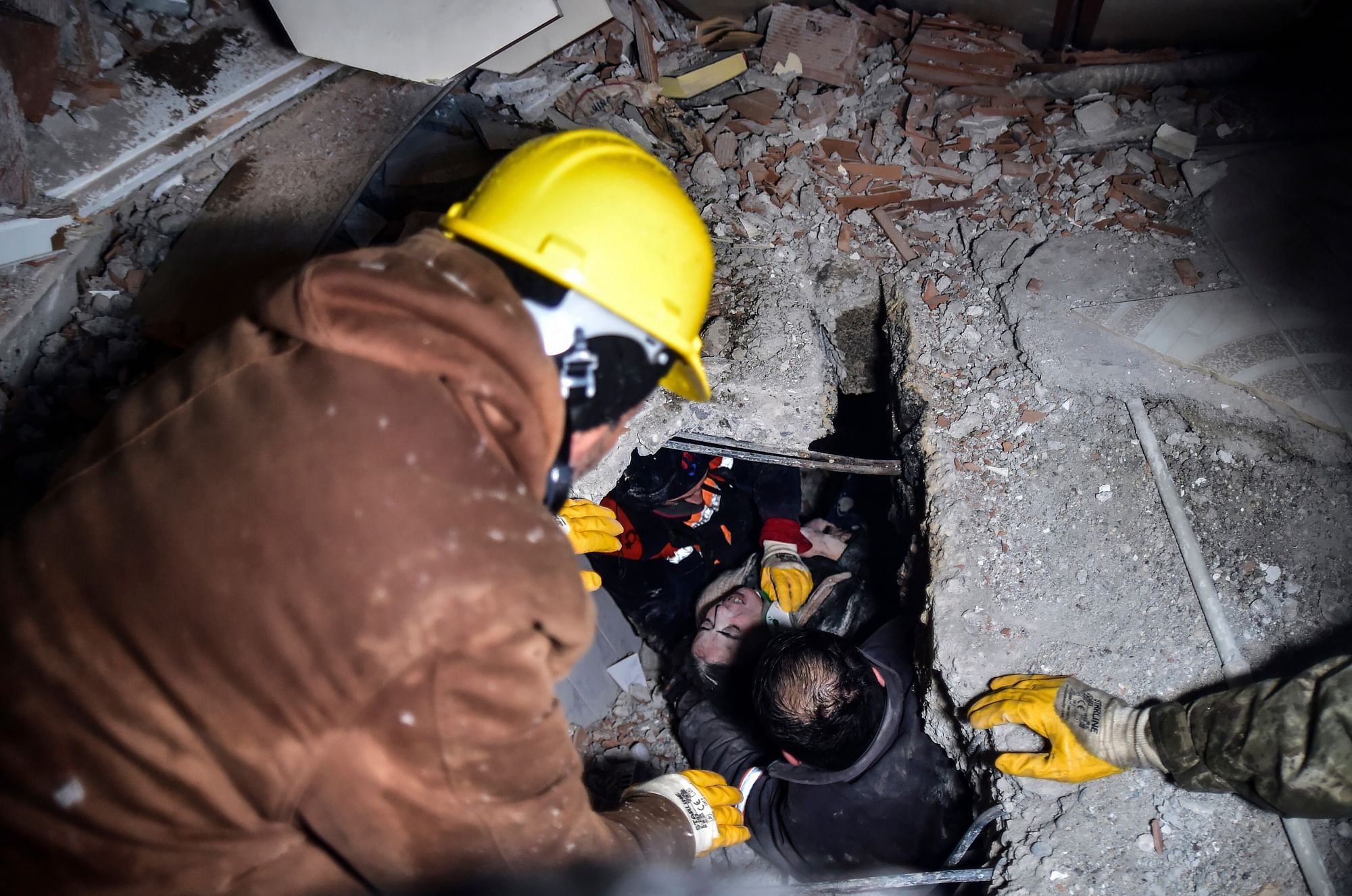 <div class="paragraphs"><p>Emergency workers and medics rescue a woman out of the debris of a collapsed building in Elbistan, Kahramanmaras, in southern Turkey.</p></div>