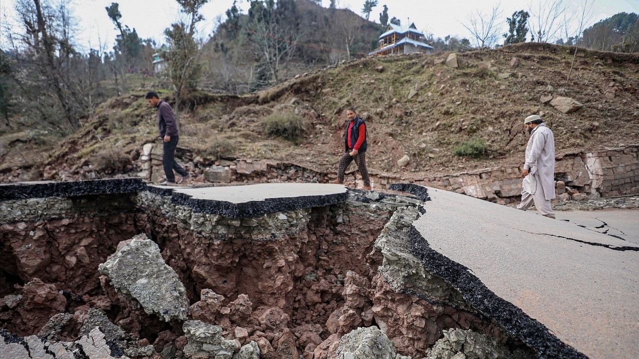 <div class="paragraphs"><p>Ramban: Locals walk on the damaged Sangaldan-Gool road following a landslide, in Ramban district of Jammu and Kashmir on Monday, 20 February.</p></div>