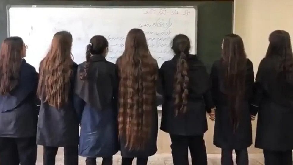 <div class="paragraphs"><p>Iranian schoolgirls posing for a photograph without their hijabs as a mark of protest against the Iran government.&nbsp;</p></div>