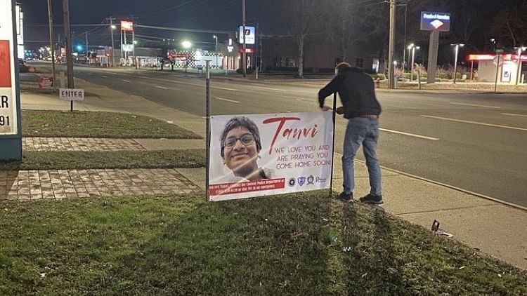 <div class="paragraphs"><p>A man putting up a banner in Conway, Arkansas, to help find Tanvi.</p></div>