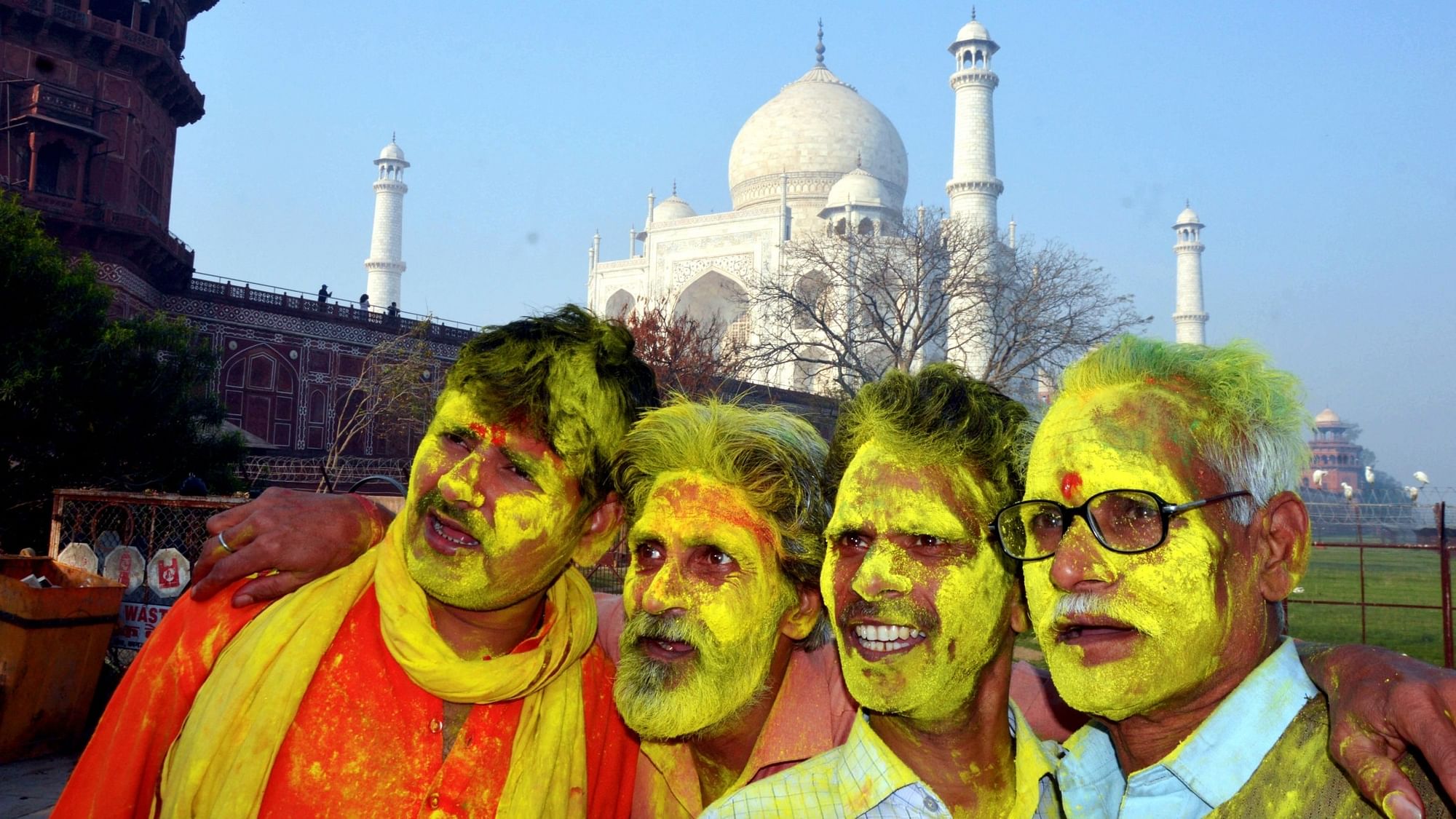 <div class="paragraphs"><p>People smeared in coloured powder during celebrations of Holi festival at Dussehra Ghat behind the Taj Mahal, in Agra. </p></div>