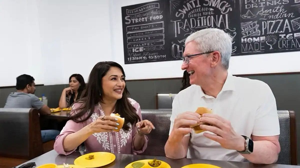 <div class="paragraphs"><p>Madhuri Dixit and Tim Cook enjoy a vada pav.</p></div>