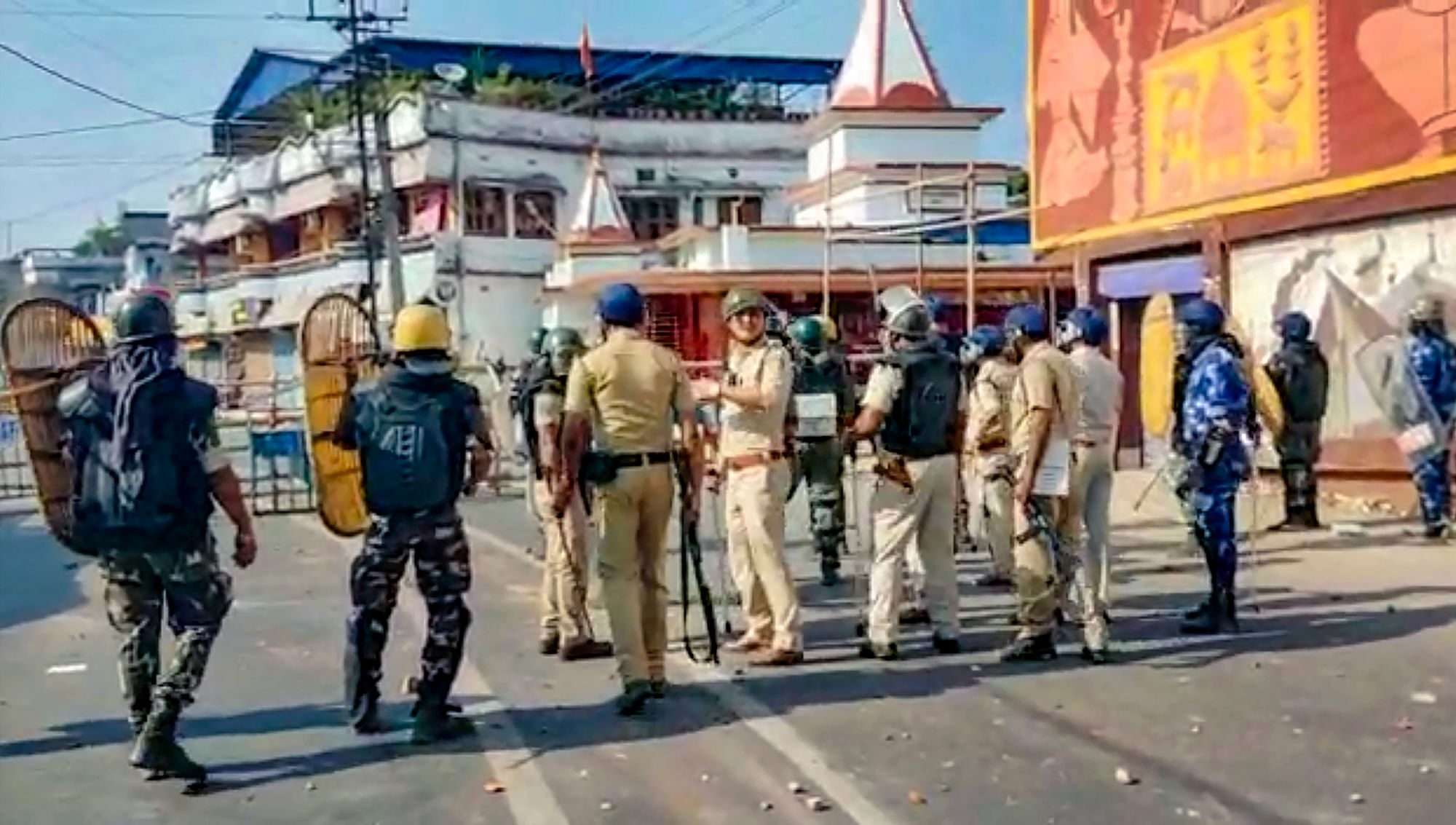 <div class="paragraphs"><p>Security personnel stand guard on Tuesday, 25 April, after a group of protesters allegedly set the Kaliaganj Police Station on fire during a protest against the death of a minor girl. </p></div>