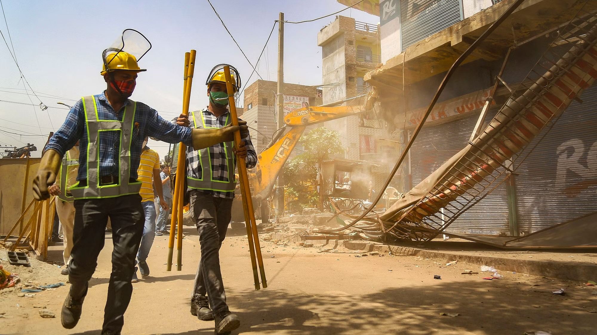 <div class="paragraphs"><p>A bulldozer being used to demolish structures during the razing drive by the NDMC, PWD, local bodies and the police, in Jahangirpuri area, in New Delhi, on Wednesday, 20 April.</p></div>