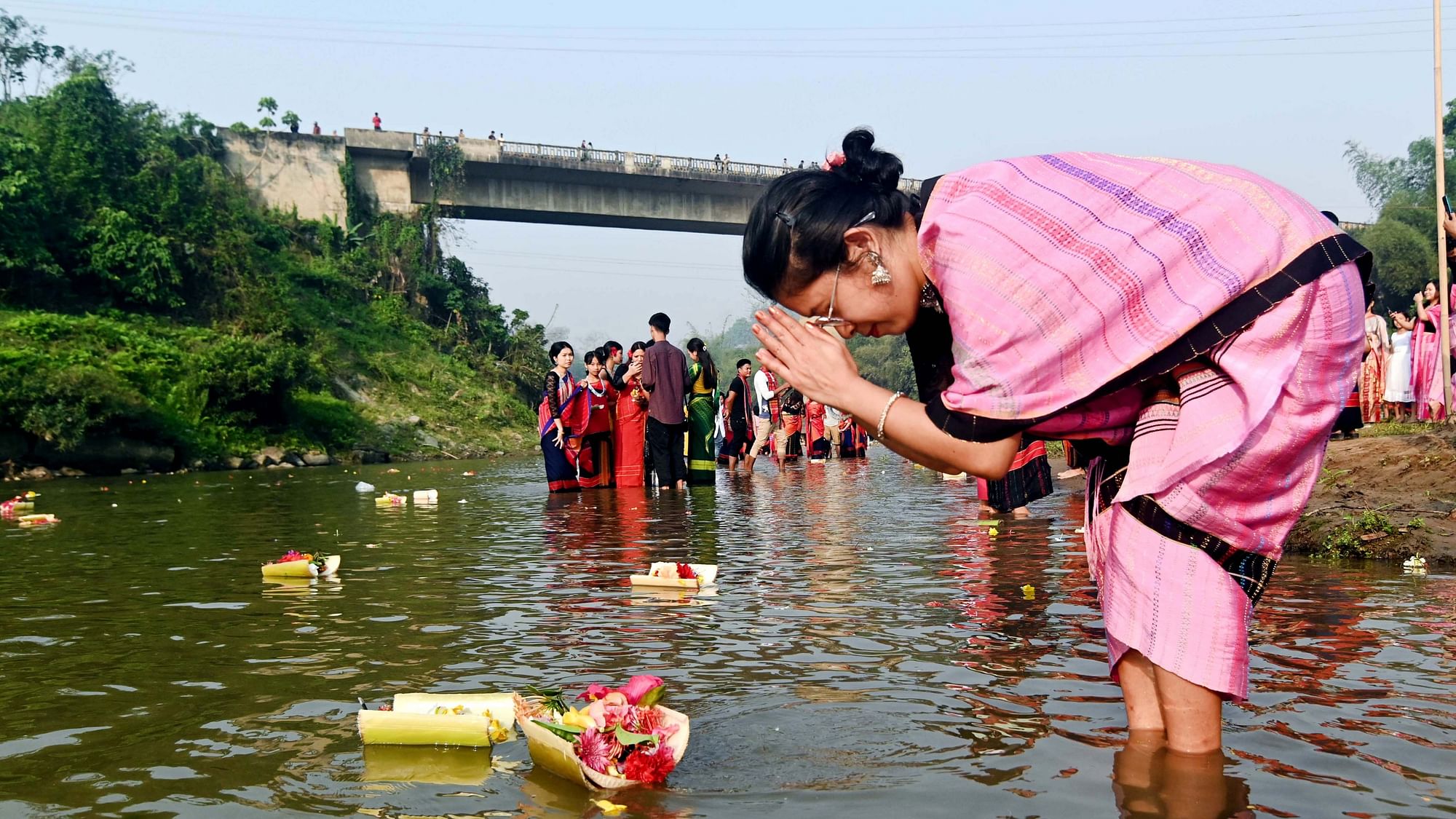 <div class="paragraphs"><p>Unakoti: A Chakma woman floats flowers on the Dew River during the Biju festival at Pencharthal in Tripura's Unakoti district on Thursday, 13 April.</p></div>
