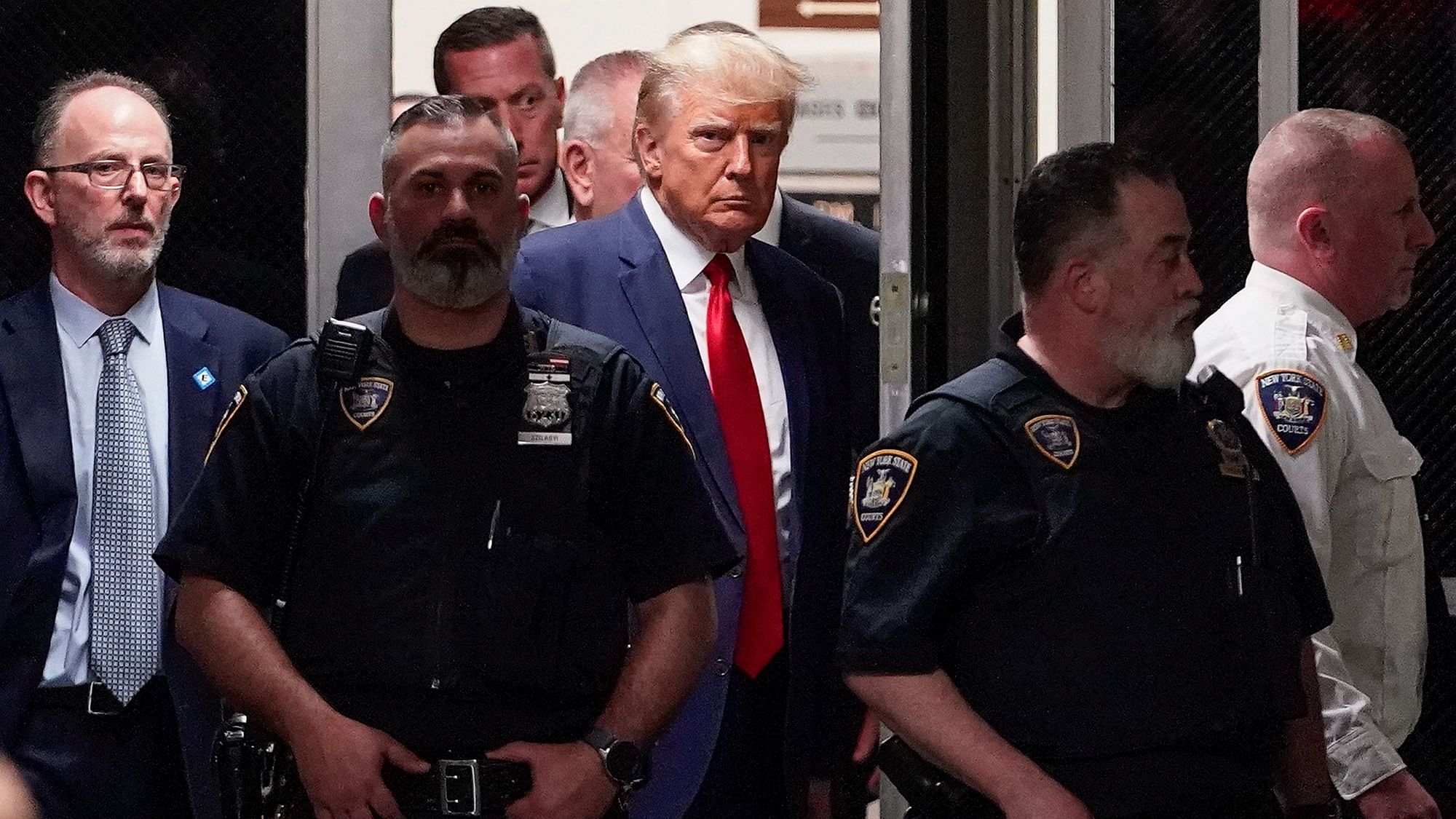 <div class="paragraphs"><p>Former US President Donald Trump being escorted to a courtroom on Tuesday, 4 April in New York. </p></div>