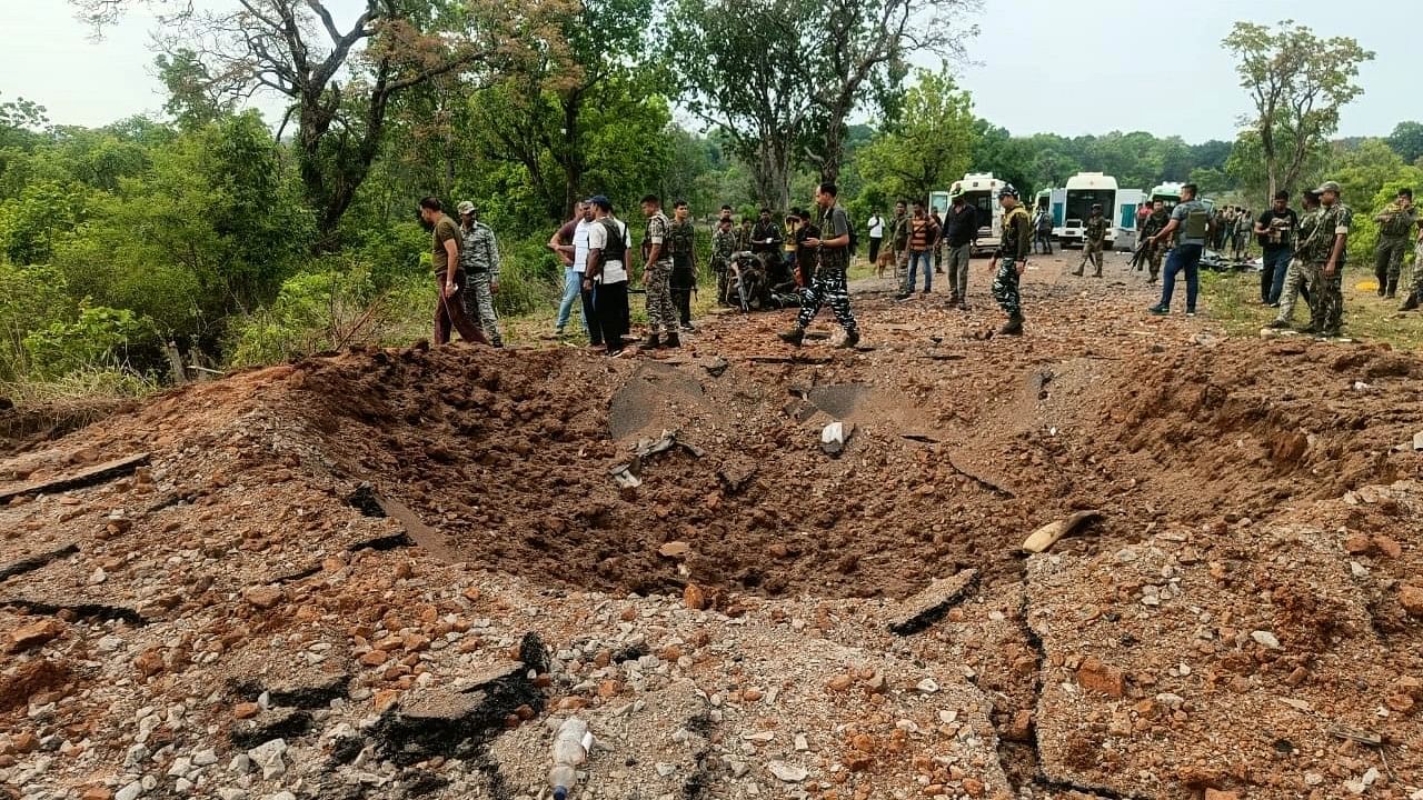 <div class="paragraphs"><p>Security personnel at the site after at least 10 police personnel and a driver were killed in a blast carried out by Maoists in Chhattisgarh's Dantewada district.</p></div>