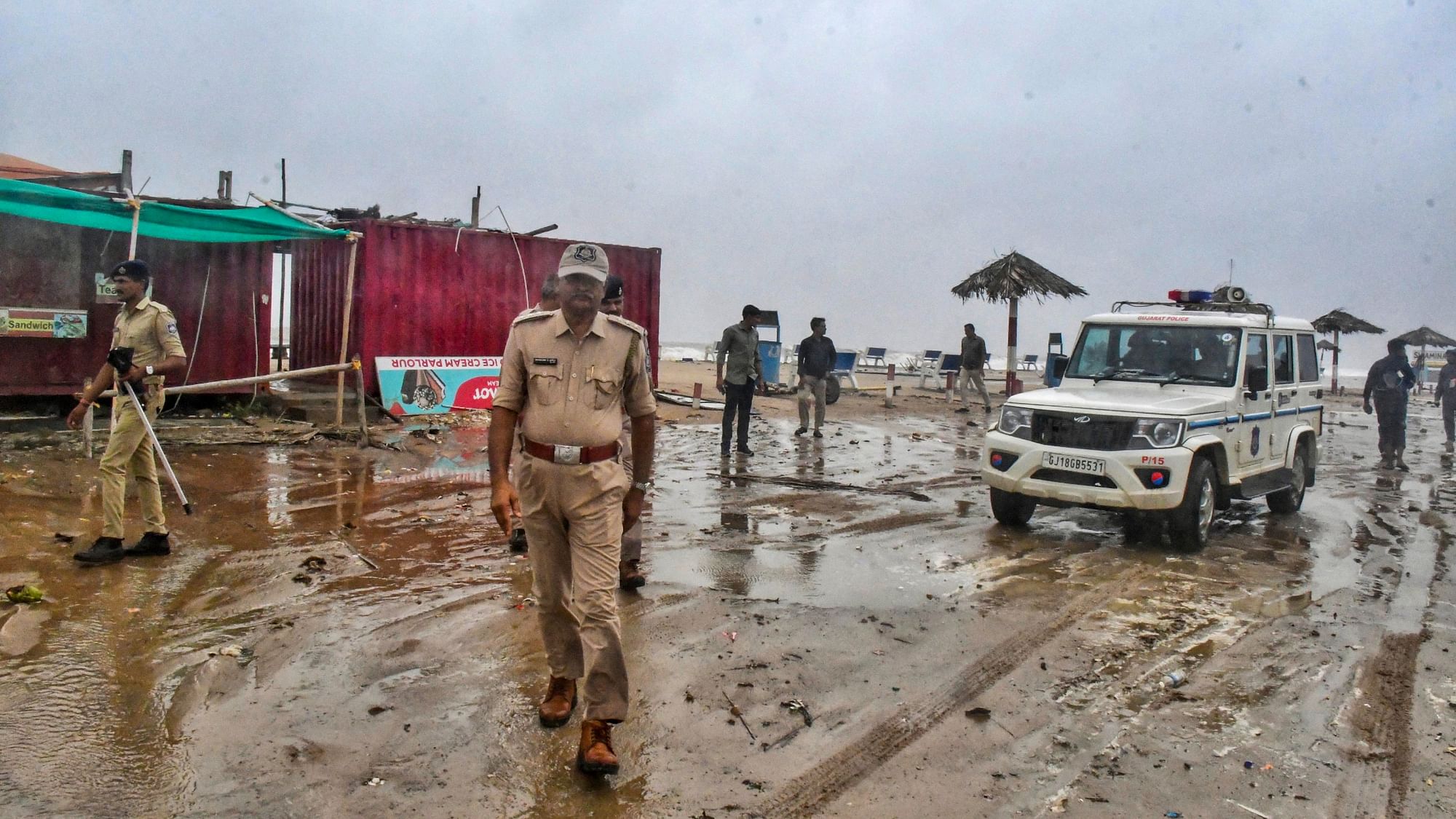 <div class="paragraphs"><p>Kutch: Police personnel stand guard at Mandvi beach as cyclone Biparjoy starts making landfall, in Kutch, Thursday, 15 June.</p></div>