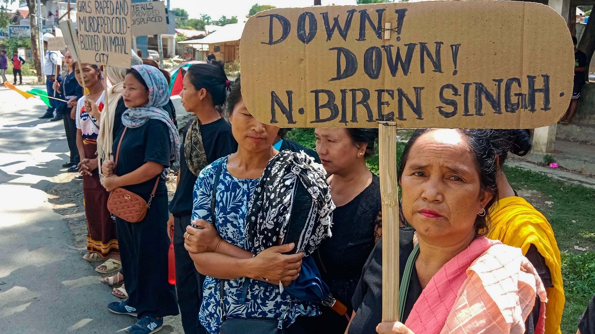 <div class="paragraphs"><p>Kuki tribals holding a placard take part in a rally during the visit of Union Home Minister Amit Shah, at Churachandpur in Manipur on Tuesday, 30 May.</p></div>
