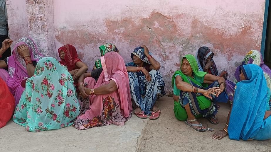 <div class="paragraphs"><p>Villagers gathered outside the family of the man who died by suicide in UP's Akorhi village.</p></div>