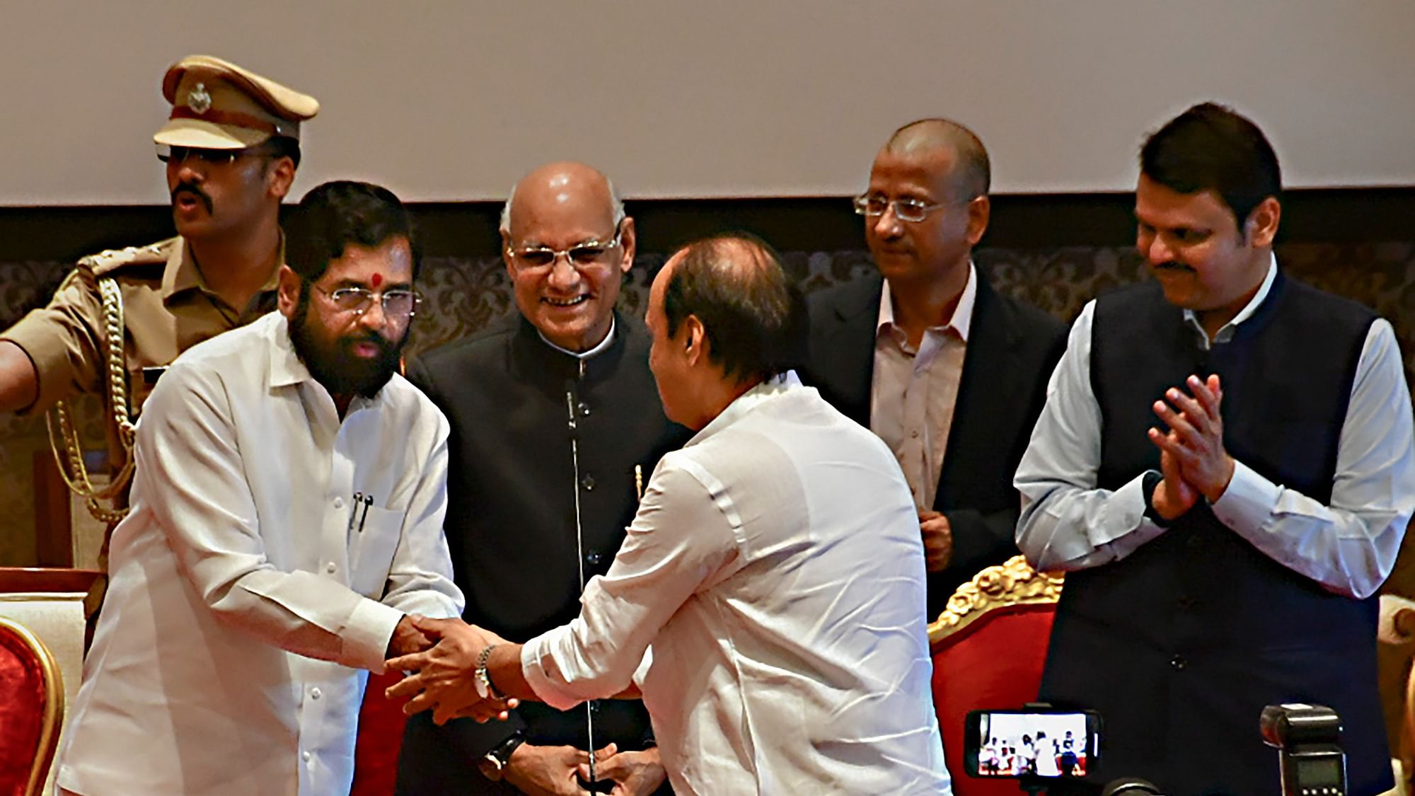 <div class="paragraphs"><p>Maharashtra Chief Minister Eknath Shinde congratulates the newly sworn-in Deputy Chief Minister Ajit Pawar, during a ceremony at Raj Bhavan, in Mumbai, Sunday, July 2, 2023. </p></div>
