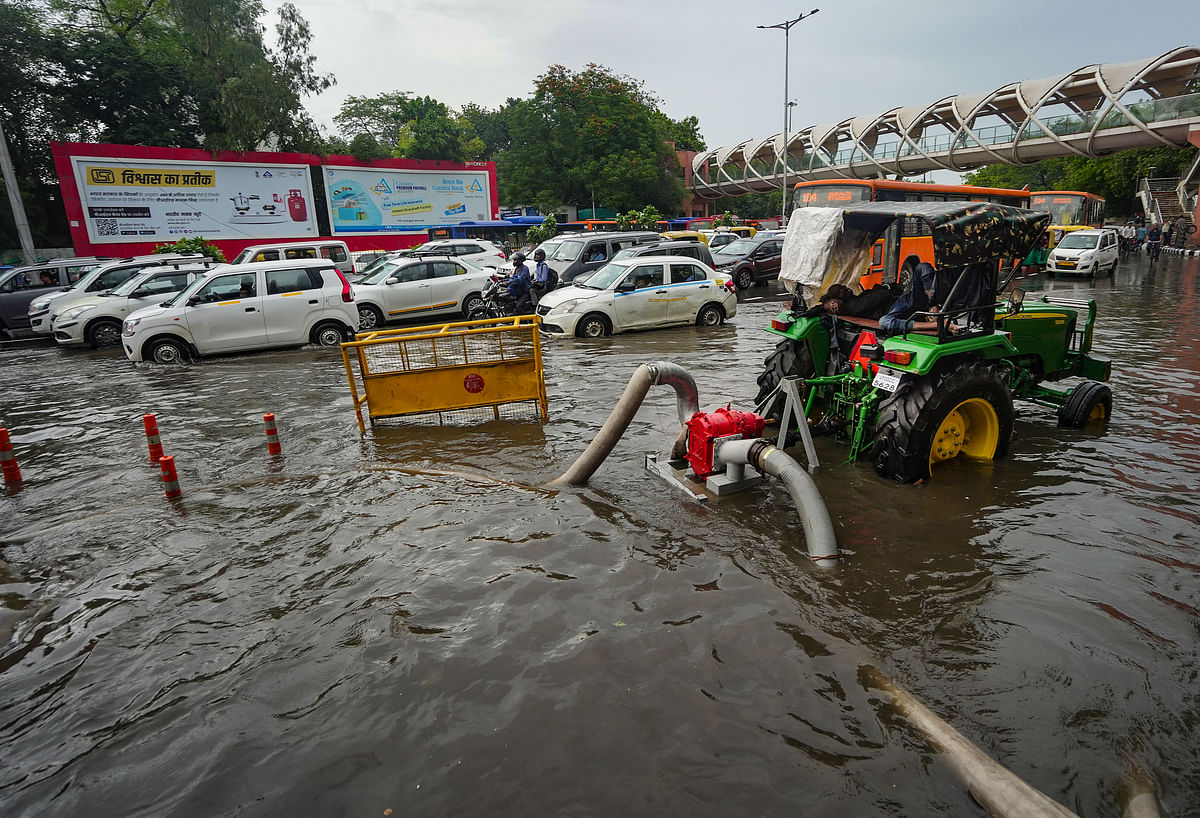 <div class="paragraphs"><p>Water being cleared from a road near Tilak Bridge after heavy monsoon rains at ITO in New Delhi on Sunday, 9 July.</p></div>