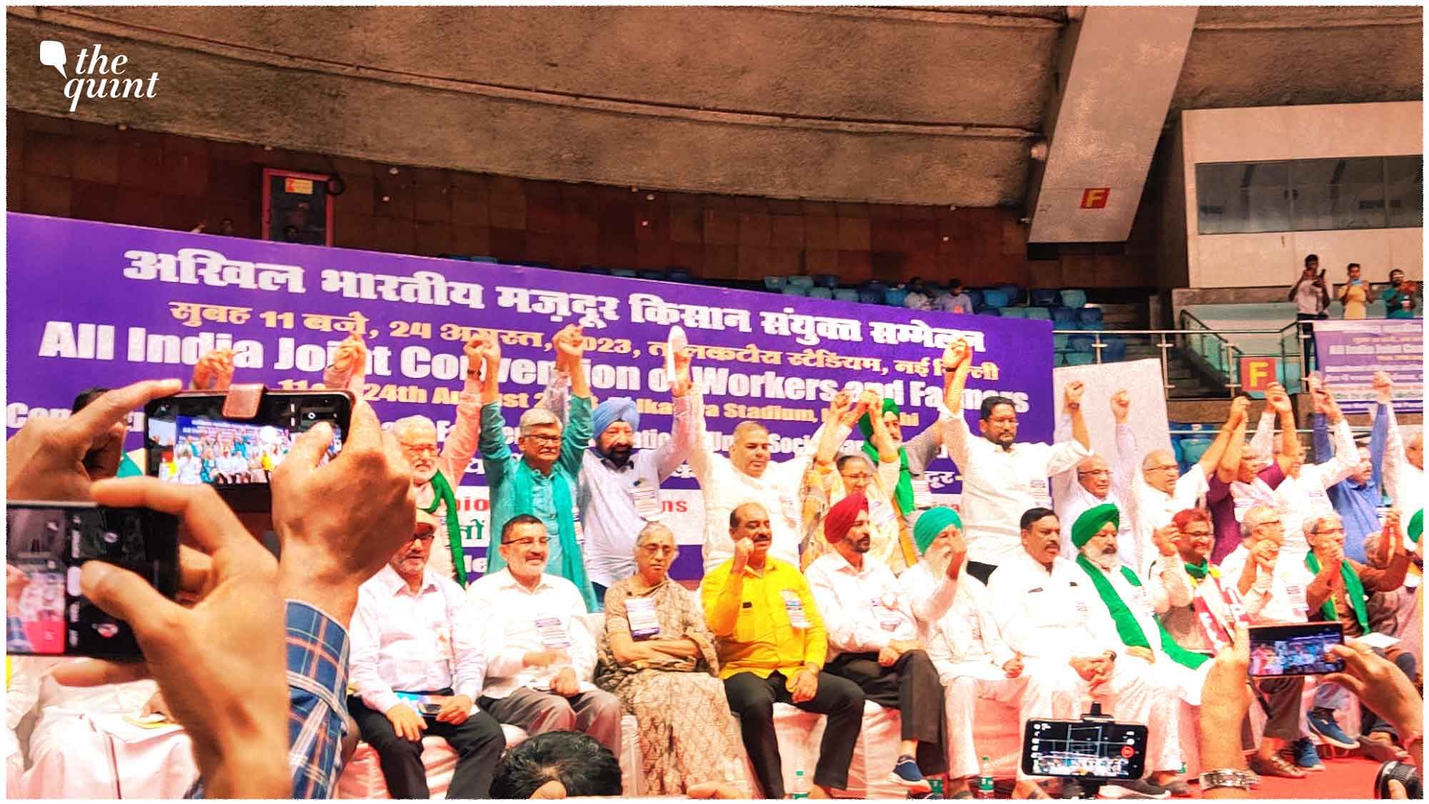 <div class="paragraphs"><p>Farmers and union leaders cheer slogans and pause their speech for a picture.</p></div>