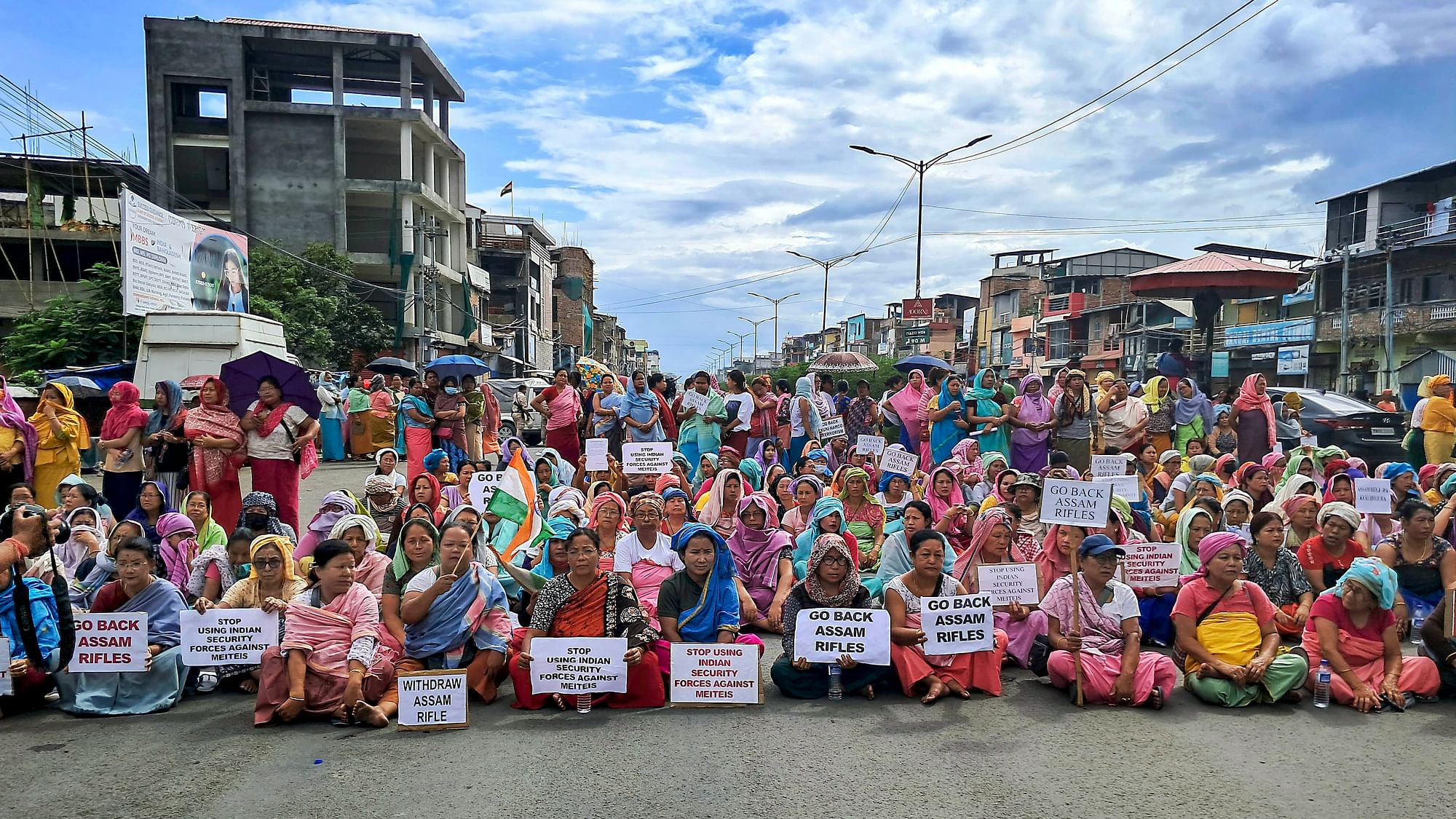 <div class="paragraphs"><p>Meitei community women block a road during a demonstration against the Assam Rifles, in Imphal, on Monday, 7 August.</p></div>