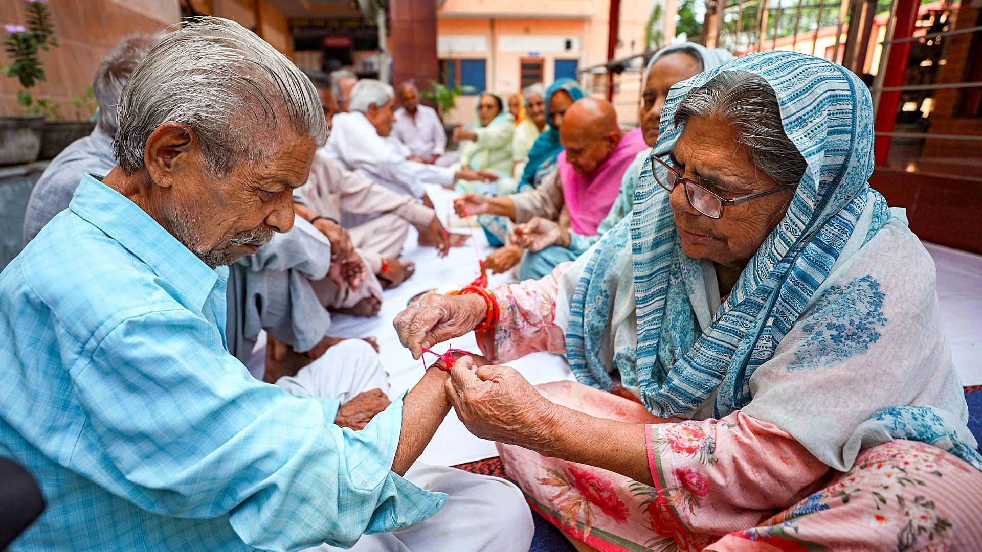 <div class="paragraphs"><p>Elderly women tie rakhi on the occasion of Raksha Bandhan festival at an old age home in Jammu on Wednesday, 30 August.</p></div>