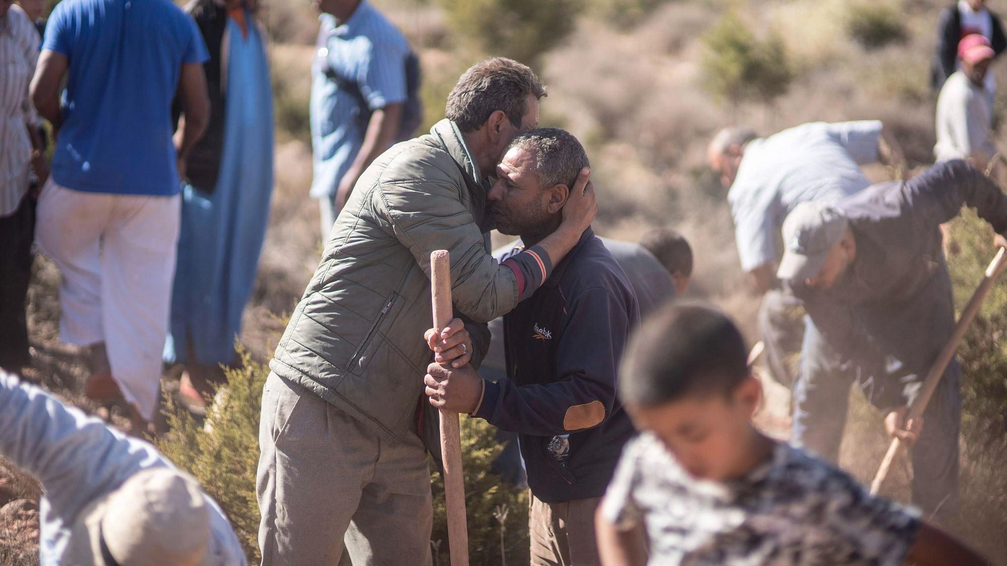 <div class="paragraphs"><p>People comfort each other while digging graves for victims of the earthquake, in Ouargane village, near Marrakech, Morocco, on Saturday, 9 September.&nbsp;</p></div>