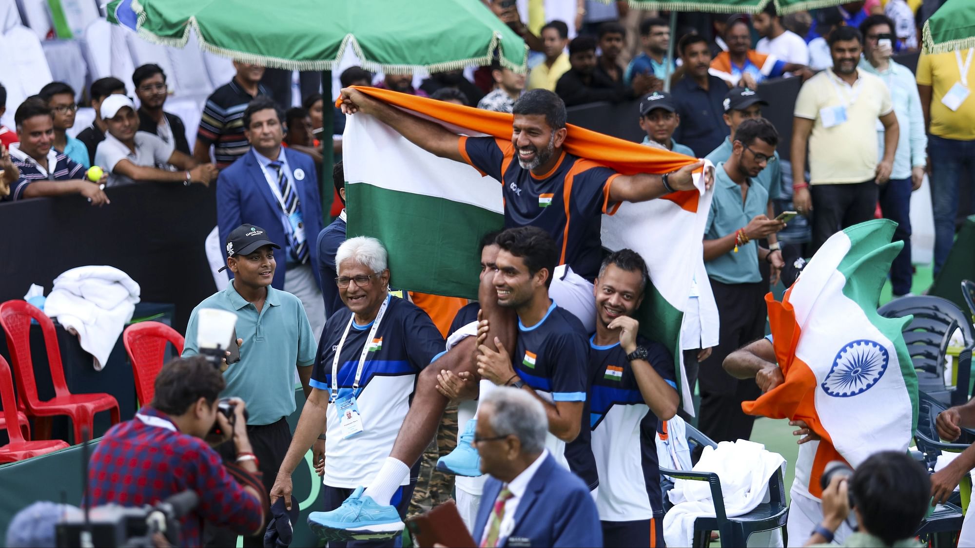 <div class="paragraphs"><p>India's Rohan Bopanna being lifted by team members at the end of India's 3-1 win over Morocco in their World Group-II Davis Cup tie in Lucknow, Sunday, Sept. 17, 2023. </p></div>